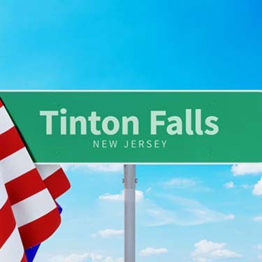 Tinton Falls – New Jersey. Road or Town Sign. Flag of the united states. Blue Sky. Red arrow shows the direction in the city. 3d rendering