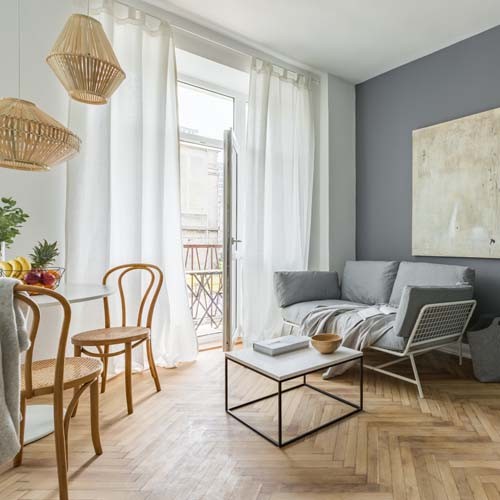 Living room, dining space and bedroom in scandinavian styled flat